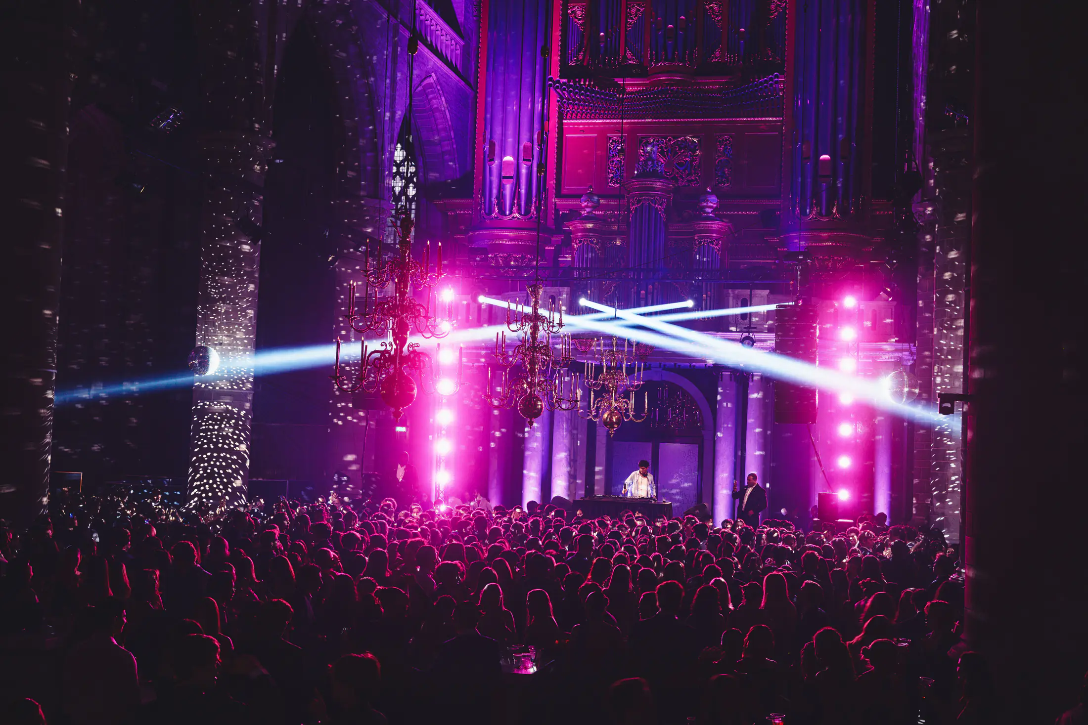 Festival stage with pink lasers and crowd atmosphere