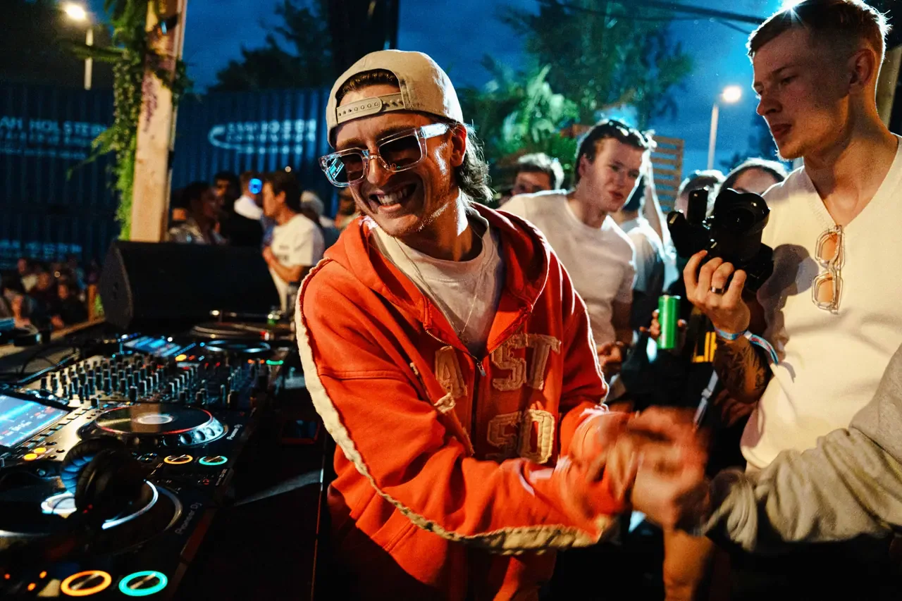 People around DJ equipment during an event
