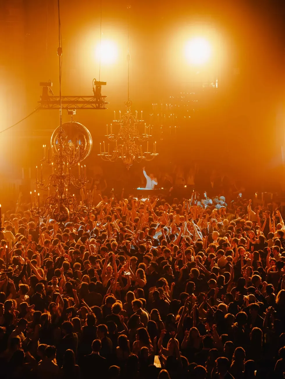 Warm-lit crowd at a music event