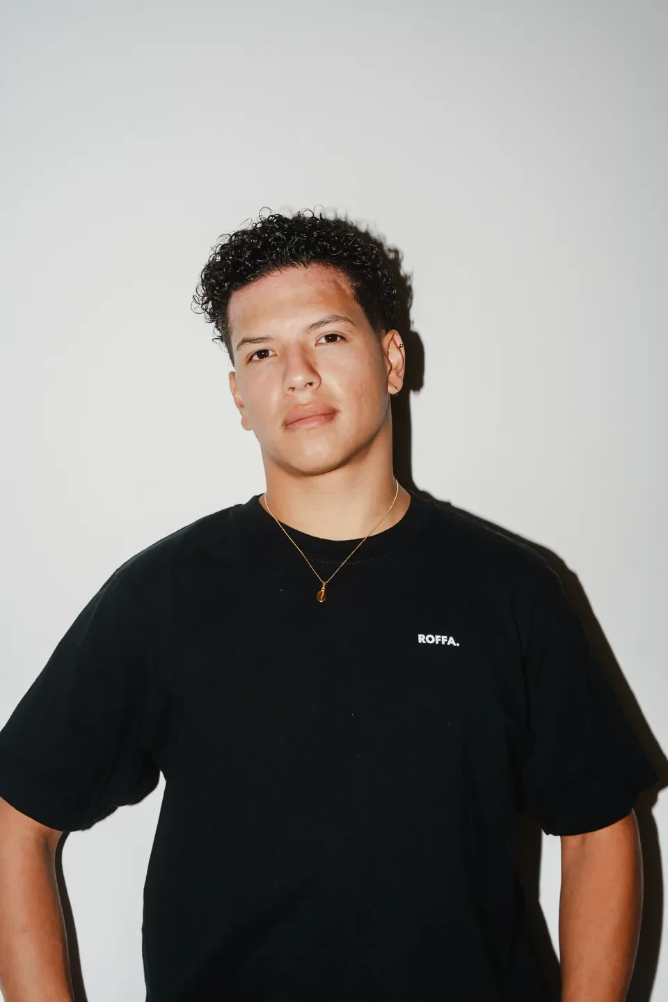 Studio portrait of a person in a black Roffa shirt